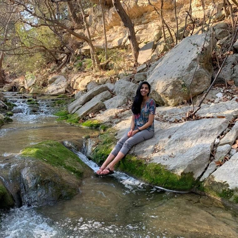 Neera sitting by the water